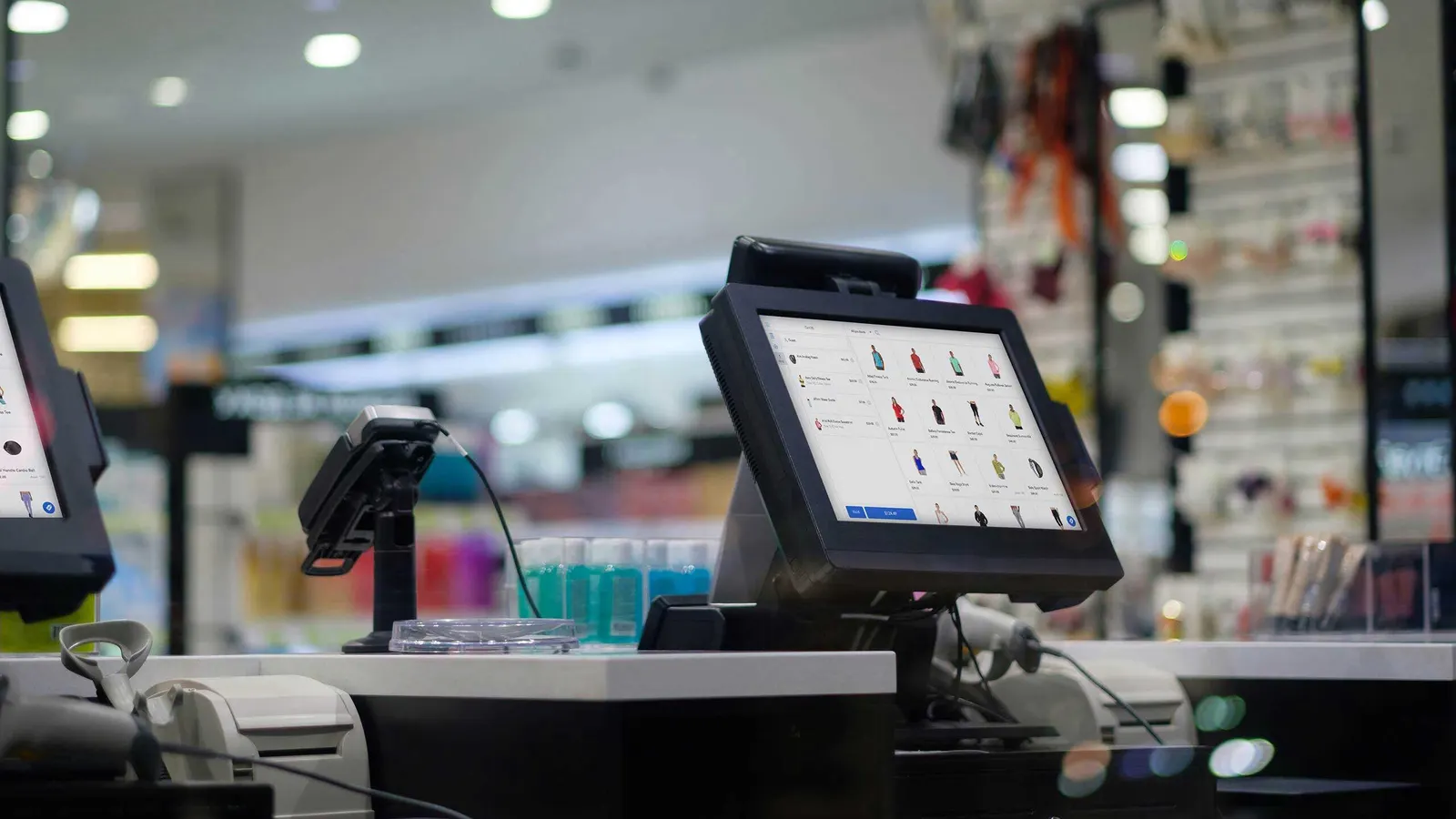 A Magestore POS terminal on a store checkout counter, showing a product grid and the cart